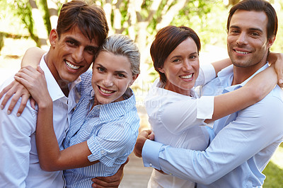 Buy stock photo Shot of two happy young couples standing together outside