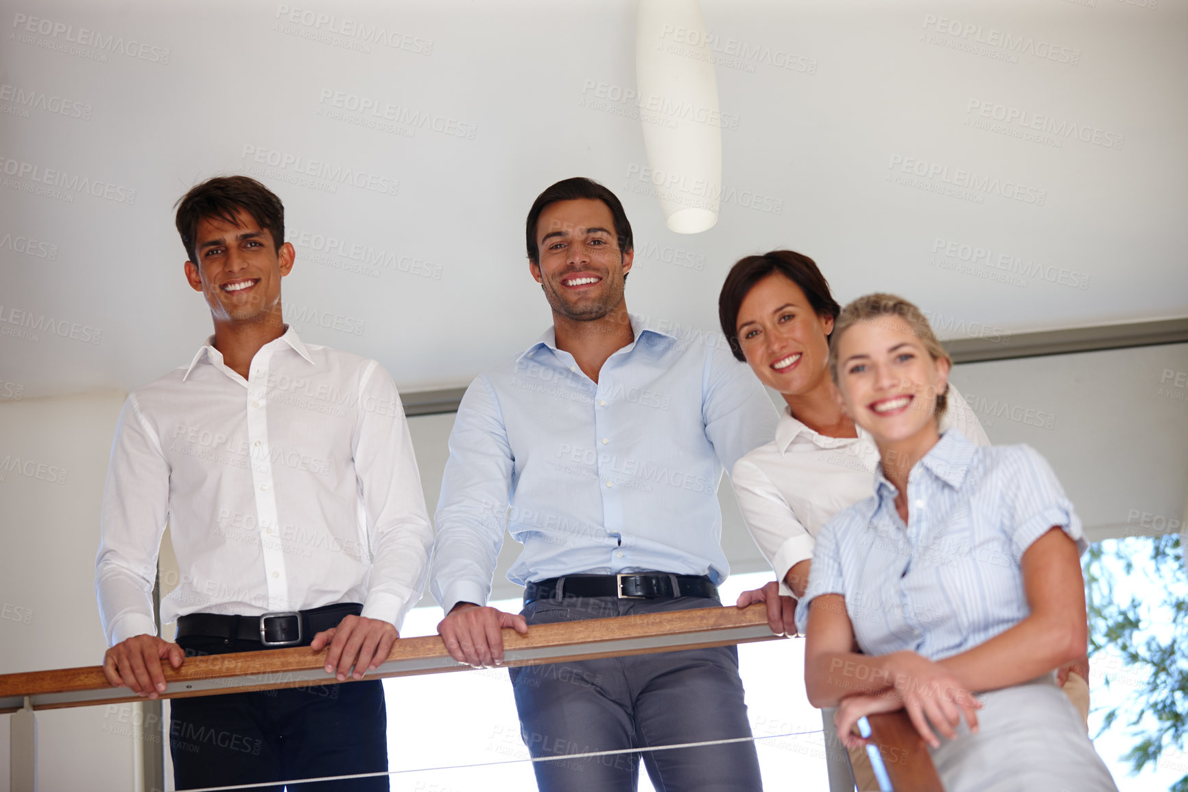 Buy stock photo Low angle portrait of a business team standing indoors