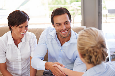 Buy stock photo Shot of a couple meeting with their financial advisor at home