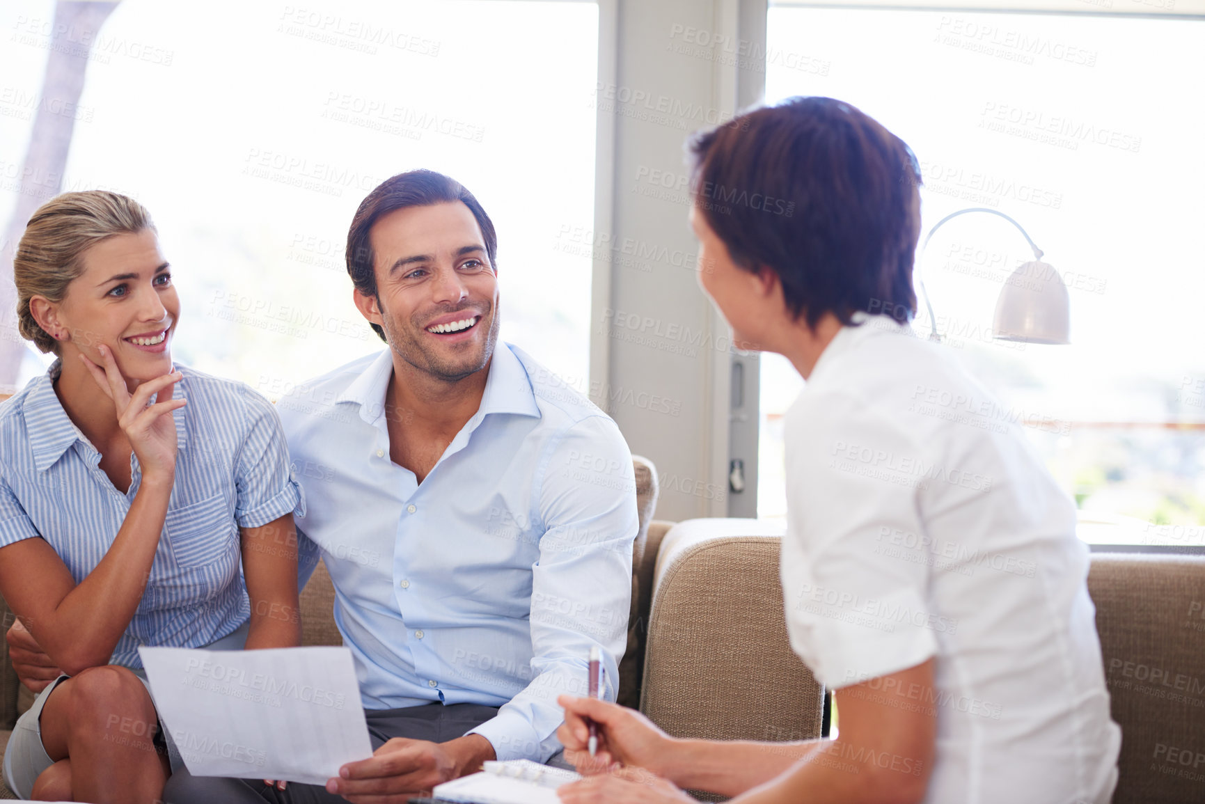 Buy stock photo Shot of a couple meeting with their financial advisor