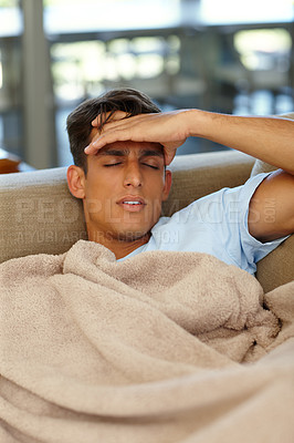 Buy stock photo Shot of a young man suffering from a headache