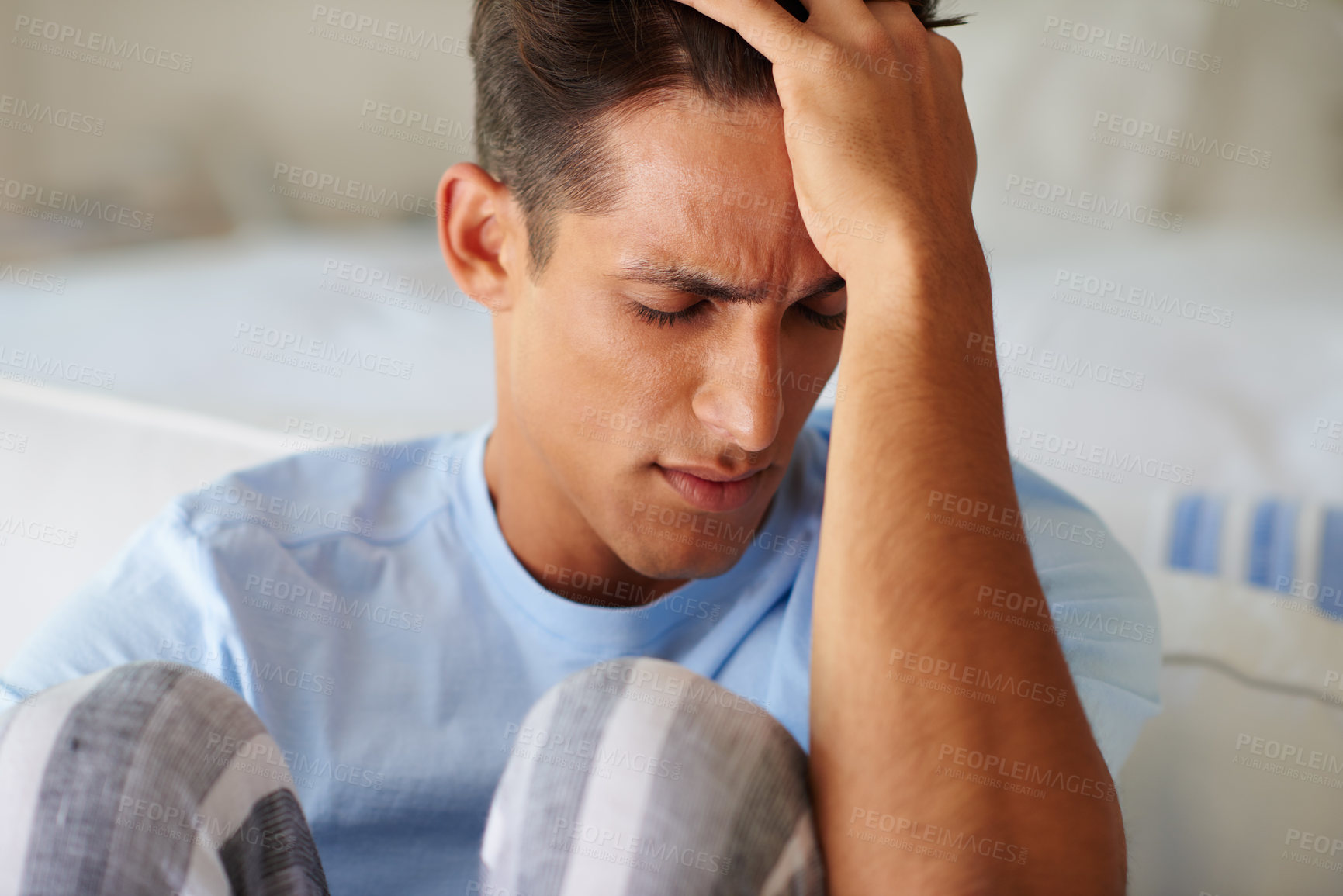 Buy stock photo Shot of a young man suffering from a headache