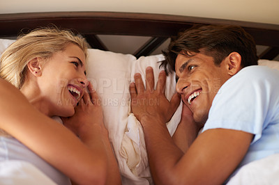 Buy stock photo Home, couple and relax with laughing in bed, bonding together and comfortable in healthy relationship. House, woman and man in bedroom for resting, funny joke and love with commitment in morning