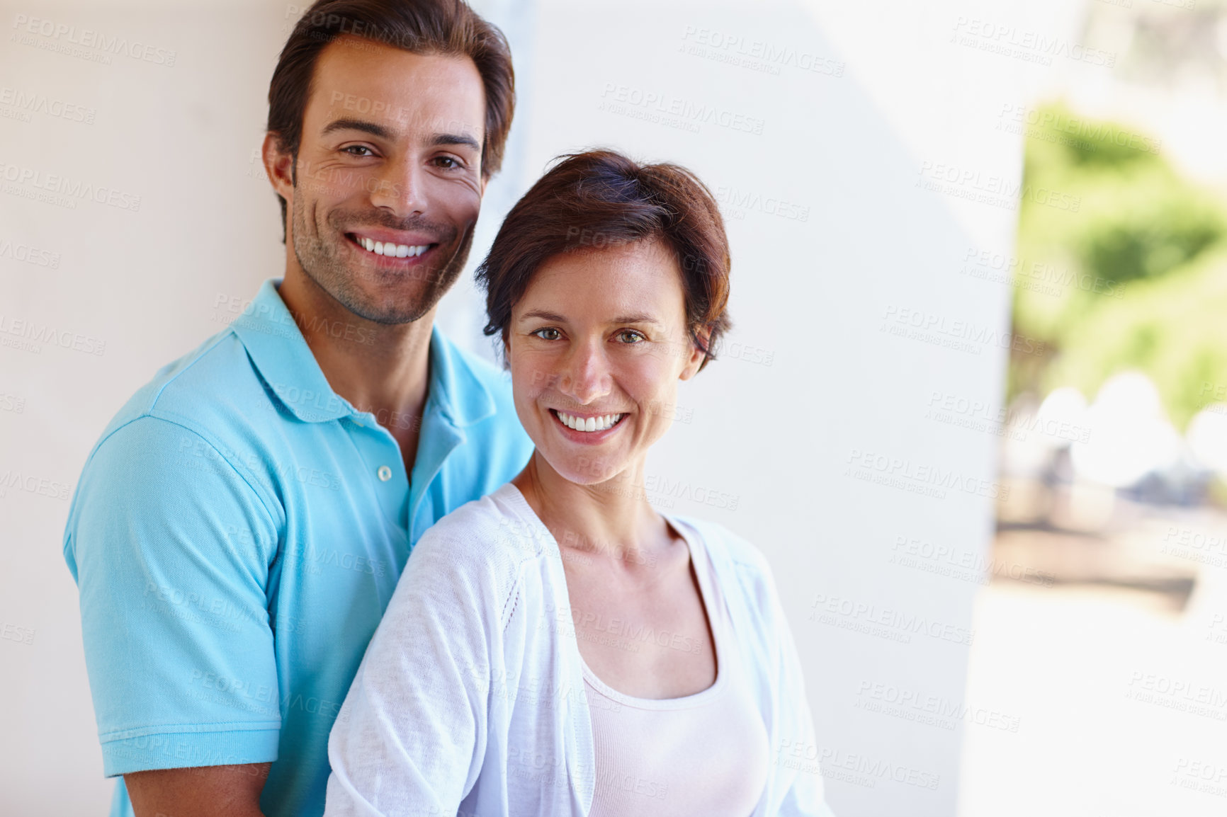 Buy stock photo Portrait of a loving married couple standing beside each other outside