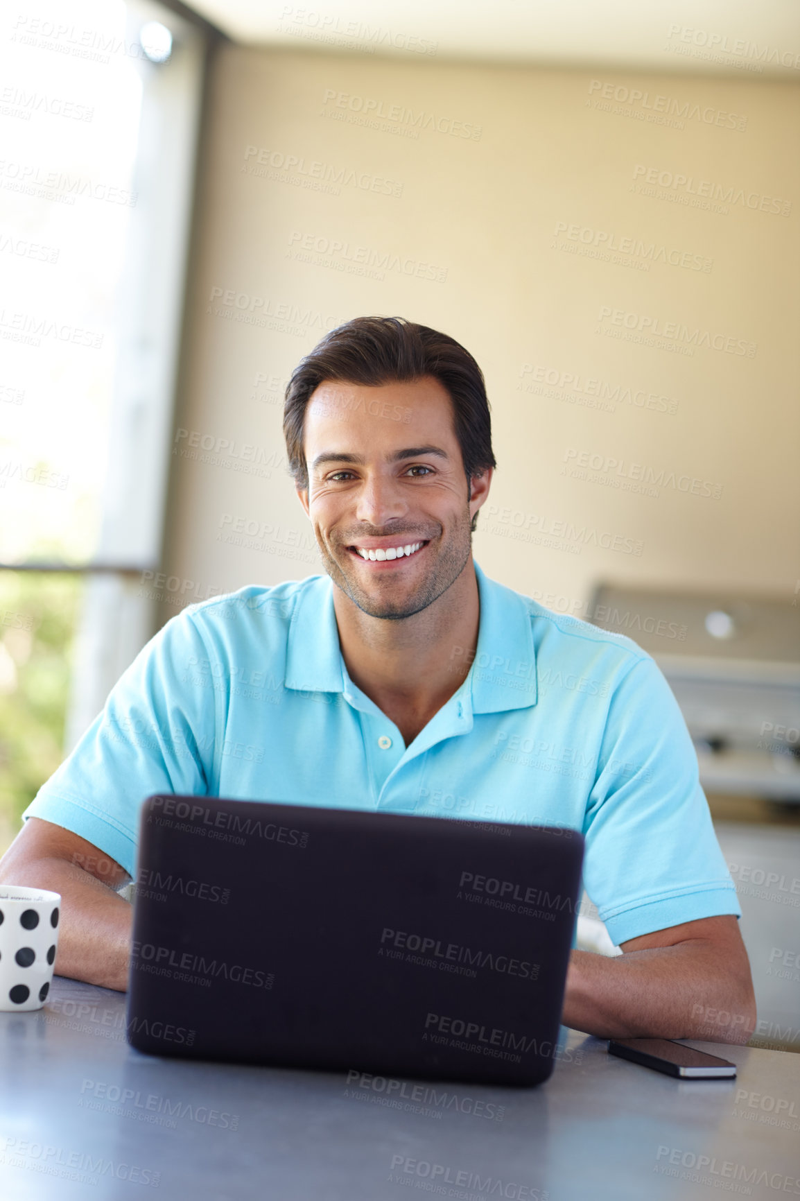 Buy stock photo Shot of a handsome man using his laptop at home