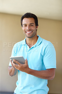Buy stock photo Portrait of a handsome man using a digital tablet indoors