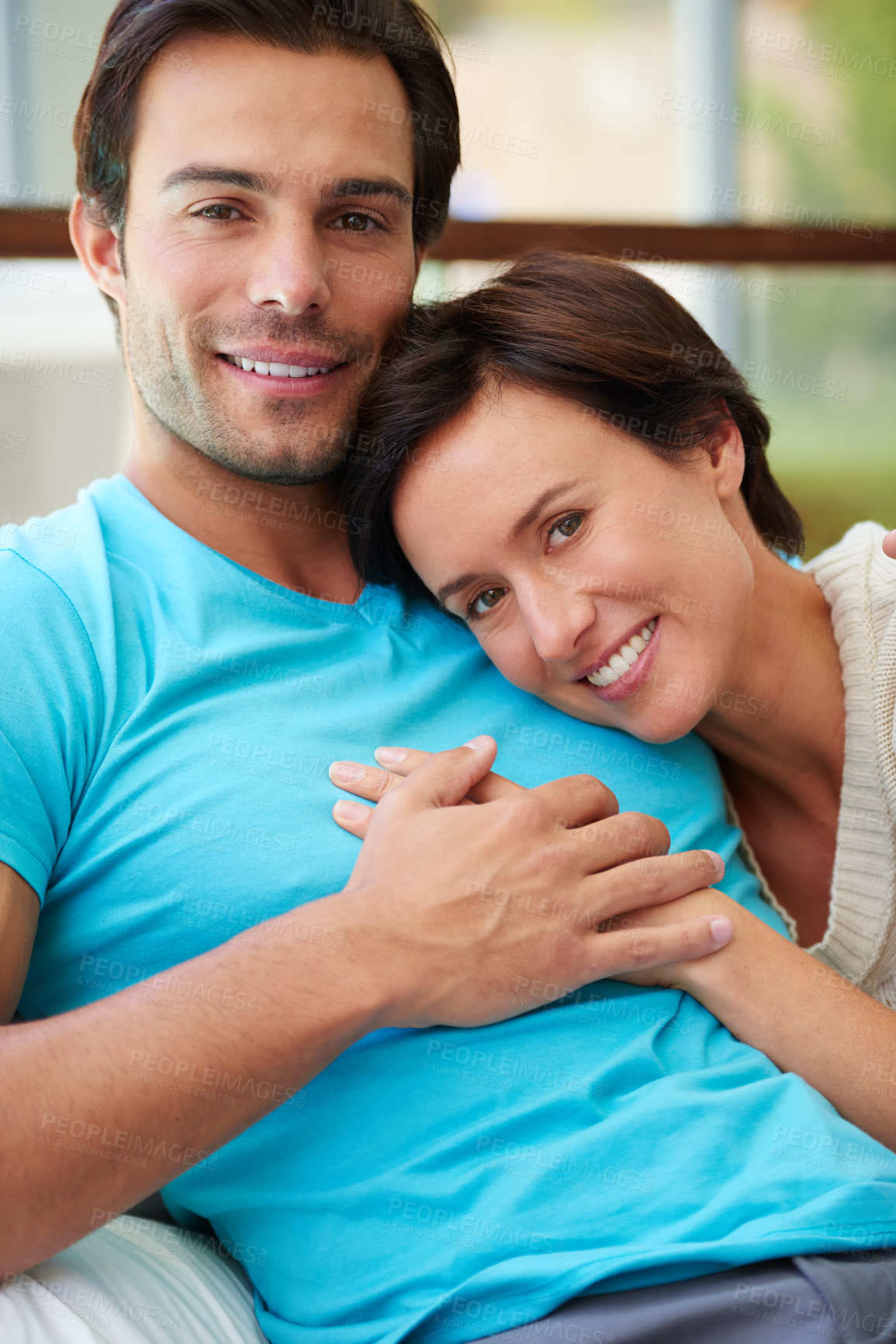 Buy stock photo Portrait of a husband and wife holding hands while relaxing at home