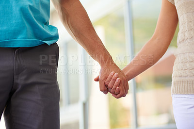 Buy stock photo Cropped shot of a couple holding hands