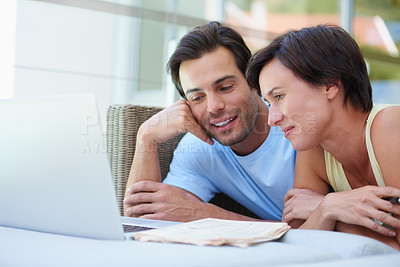 Buy stock photo Shot of a married couple working on their household budget on their computer