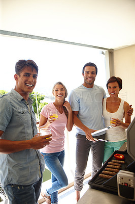 Buy stock photo Shot of a group of friends enjoying a barbeque over the weekend