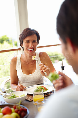 Buy stock photo Shot of an attractive woman having lunch with an unrecognizable person