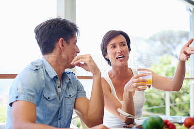 Buy stock photo Shot of a woman having a conversation with someone around the dining table