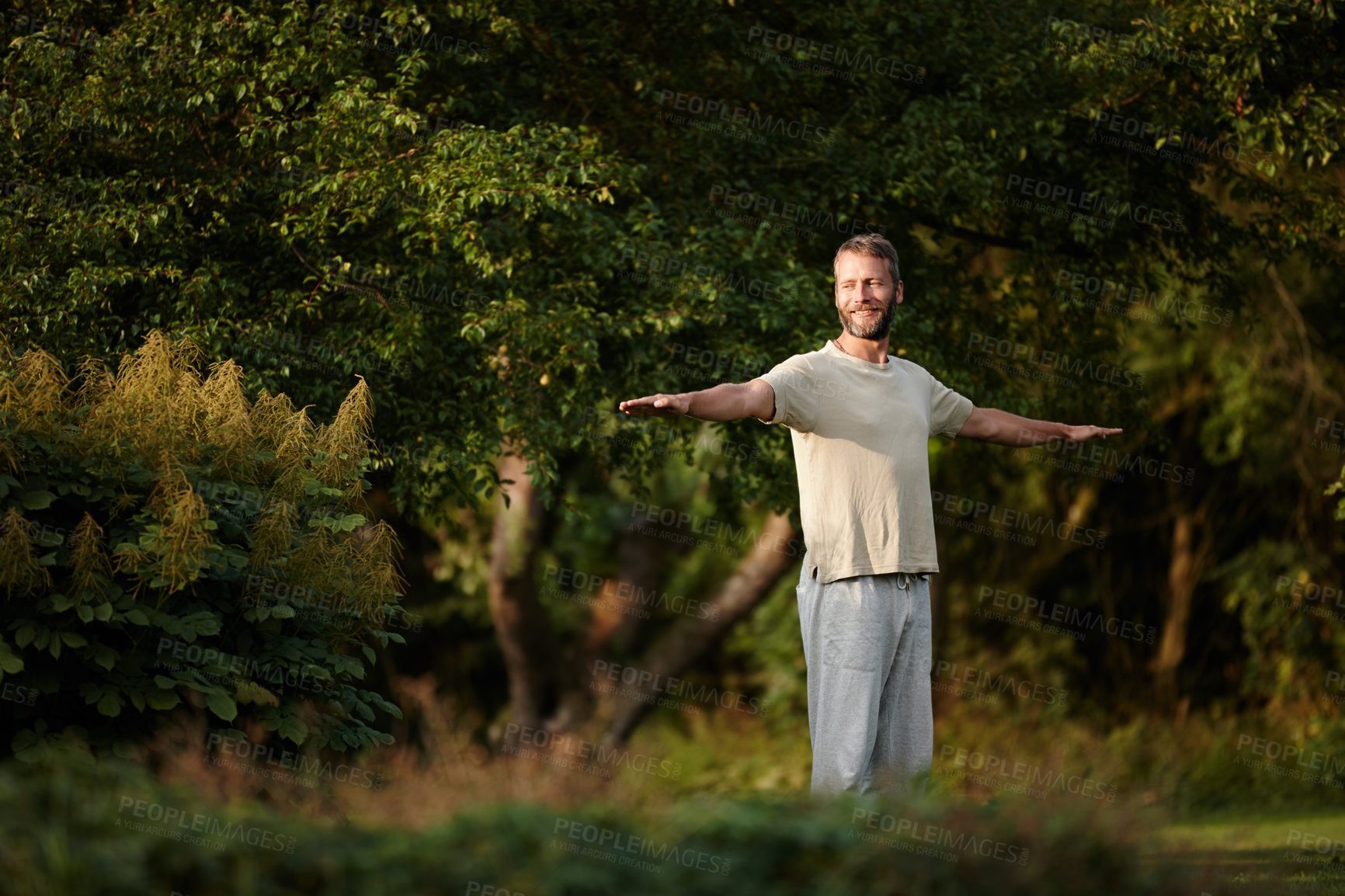 Buy stock photo Smile, man and stretching for yoga on grass with mindfulness, spiritual healing and peace at garden. Thinking, male person and warm up muscle with mental health, holistic balance and fitness wellness