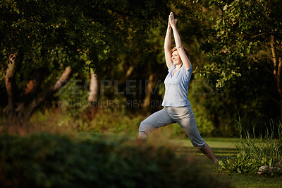 Buy stock photo Shot of an attractive woman doing yoga in the outdoors