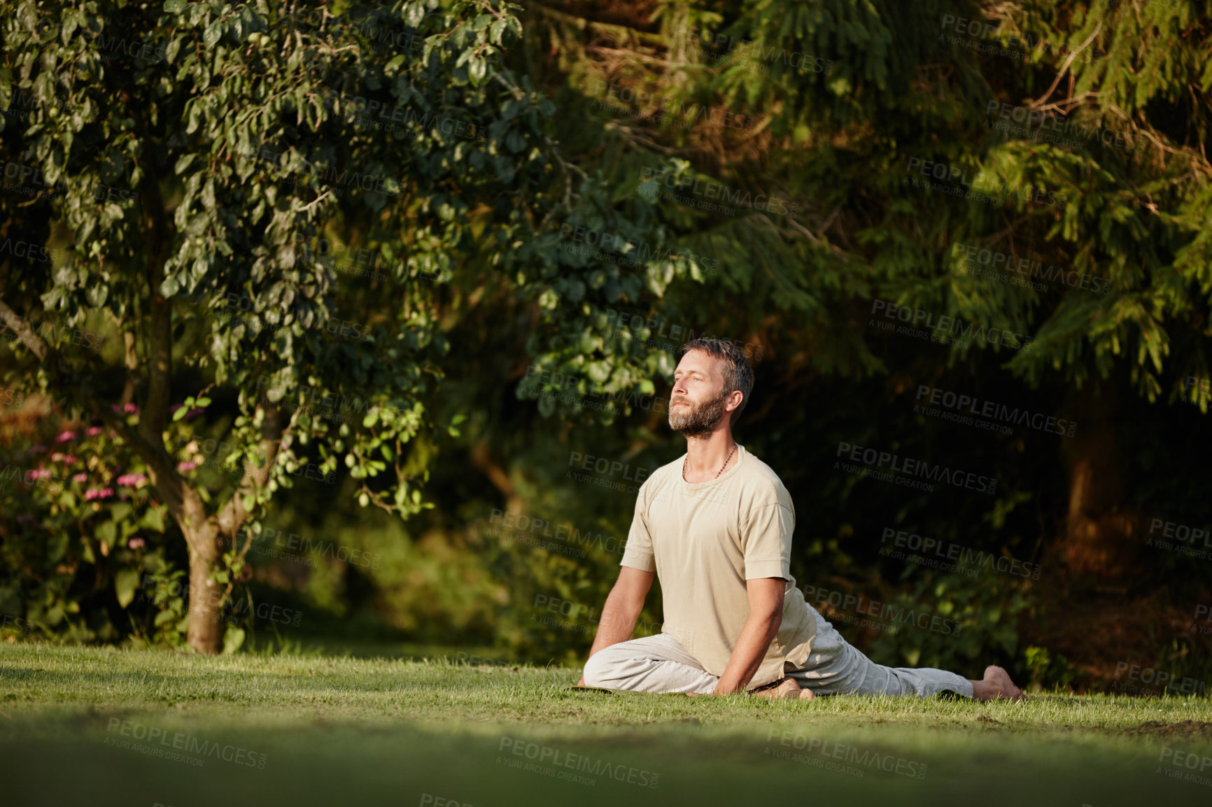 Buy stock photo Full length shot of a handsome mature man doing yoga in the outdoors