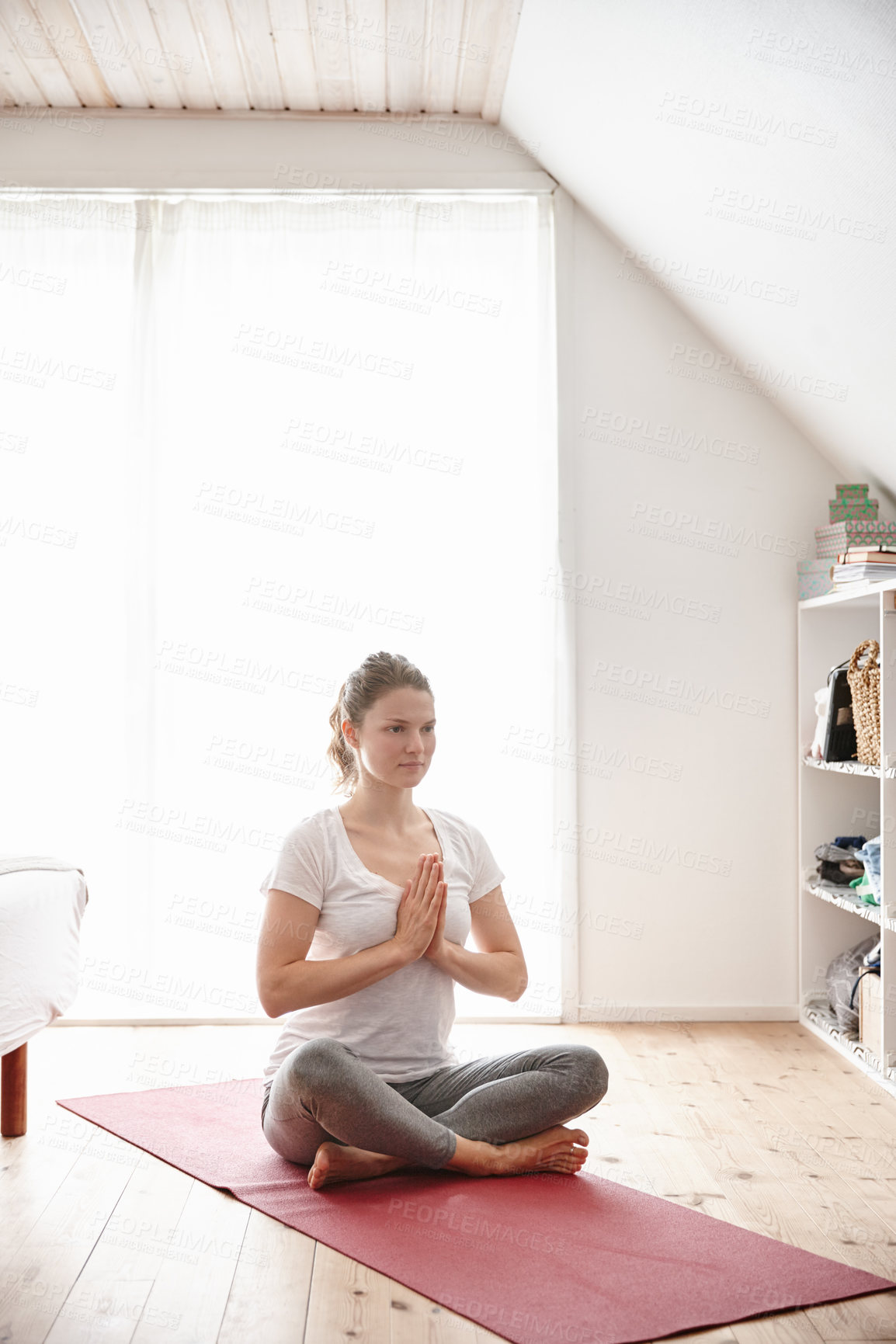 Buy stock photo Shot of an attractive young woman doing yoga at home