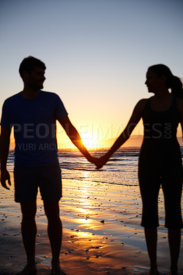 Buy stock photo Silhouette image of a couple holding hands at sunrise