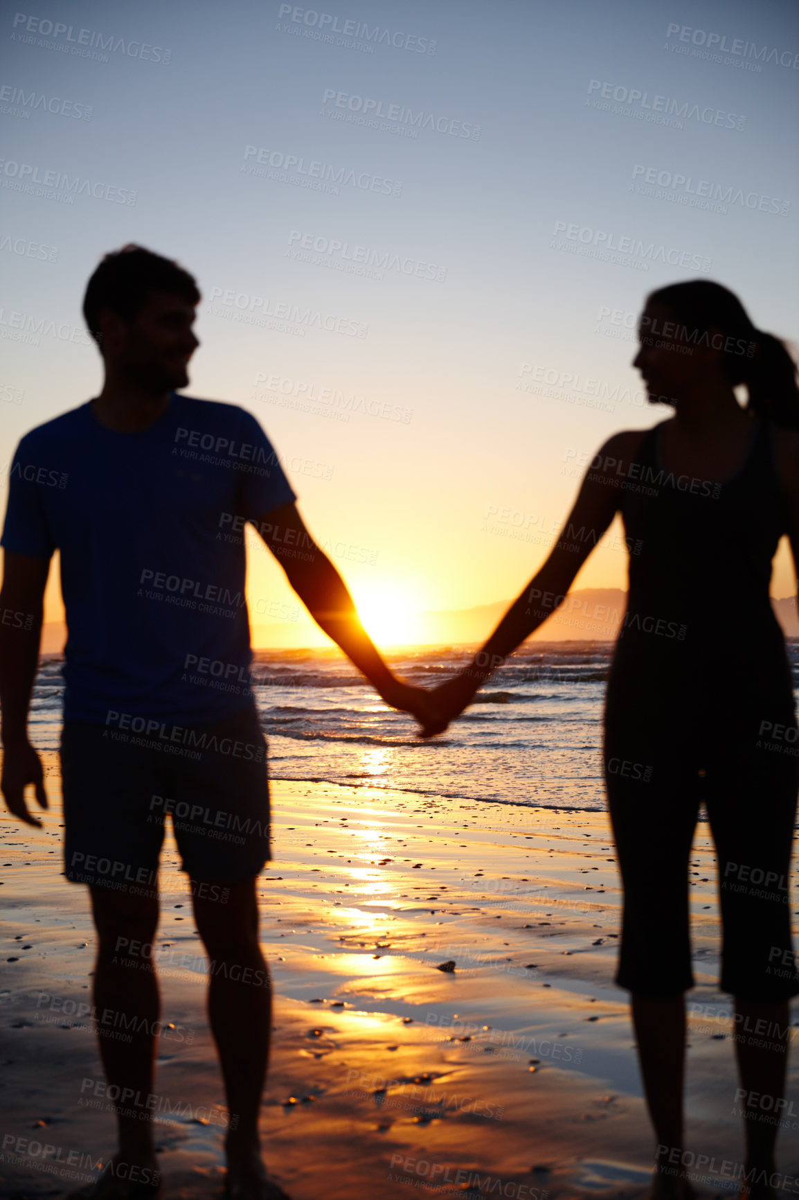 Buy stock photo Couple, silhouette and holding hands by sea, sunrise and memory with bonding for love on valentines day. People, partnership and connection with waves, ocean and outdoor on vacation in Australia