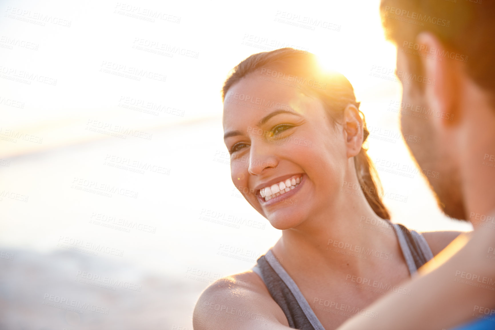 Buy stock photo Shot of a happy young woman with her boyfriend at sunrise