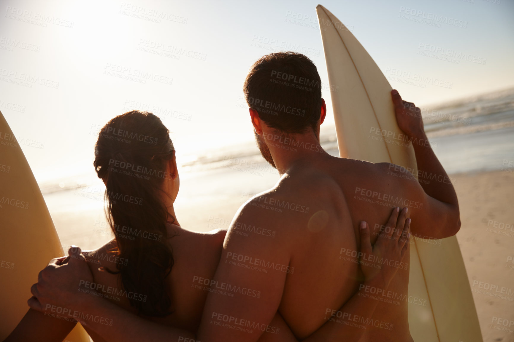 Buy stock photo Surfing, couple and hug on beach with back, waves and summer bonding together in ocean. Holiday, hobby and sea with man, woman and surfer relationship with travel break for vacation or practice