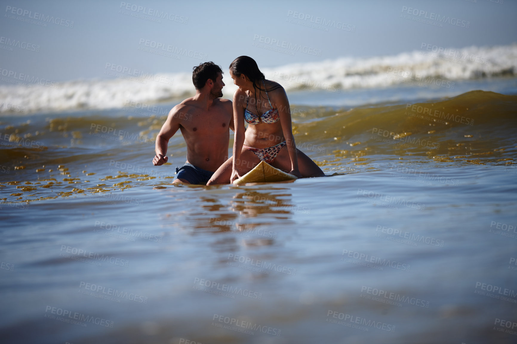 Buy stock photo Shot of a couple surfing together 