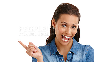 Buy stock photo Studio portrait of an attractive young woman pointing excitedly at  your copyspace