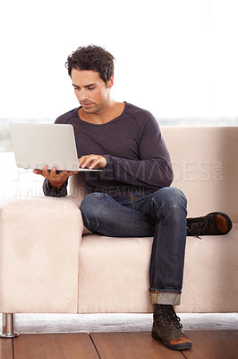 Buy stock photo Man, work from home and typing on computer for stock market investment, planning and research with website on sofa. Startup freelancer or trader on a couch, laptop and trading software for analysis