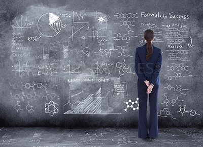 Buy stock photo Rearview shot of a businesswoman looking at financial data on a chalk board