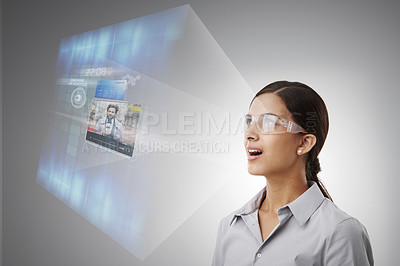 Buy stock photo Business, woman and smart glasses with hologram for projection, live streaming and news broadcast in studio. VR, 3D futuristic tech and metaverse with web innovation and surprised on gray background