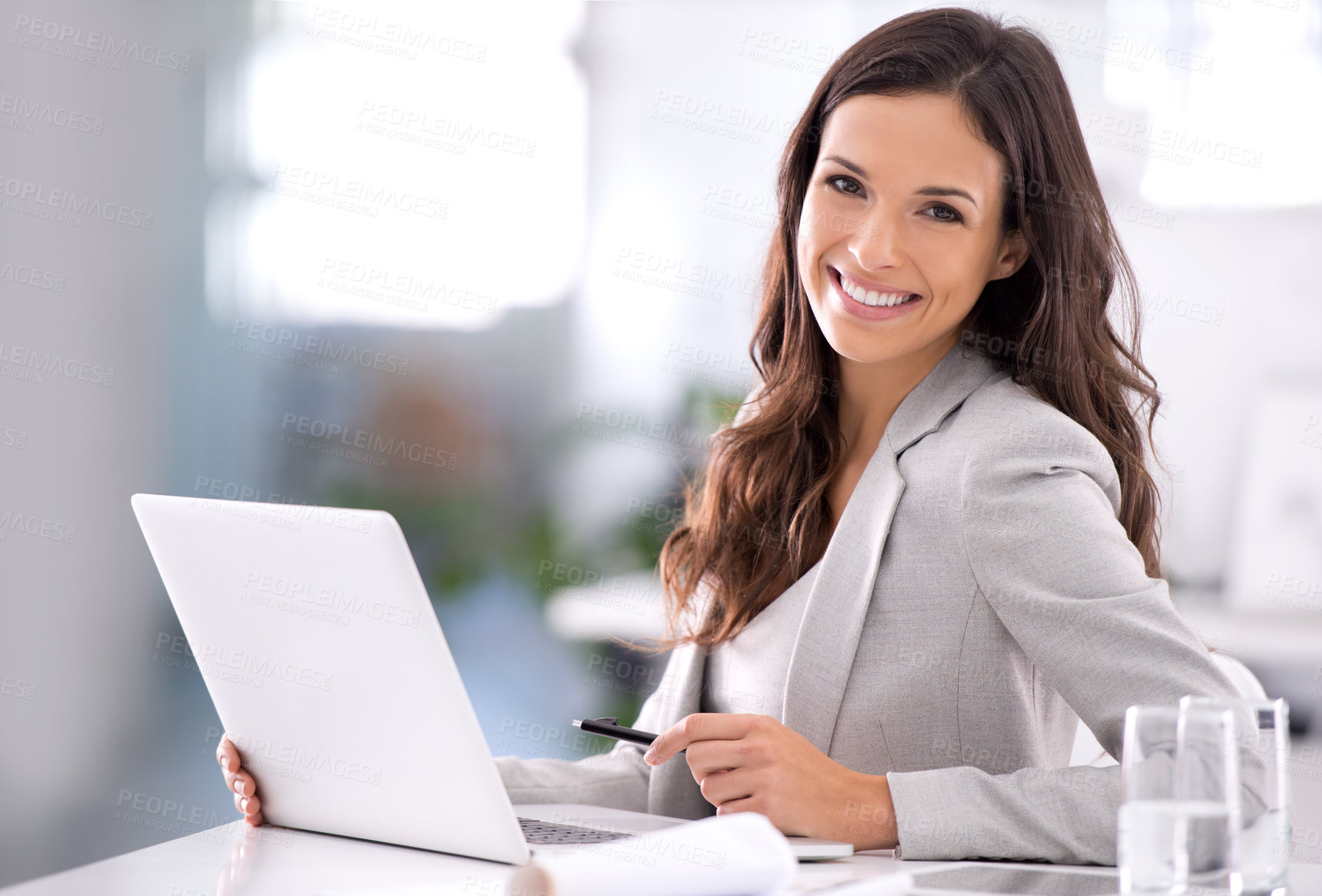 Buy stock photo Shot of an attractive businesswoman sitting at her desk in an office