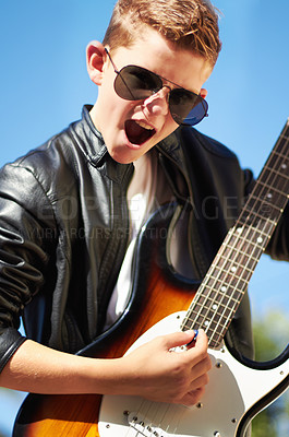 Buy stock photo Art, portrait and child with guitar in garden for creative sound, playing audio and cool young musician with sunglasses. Rock music, excited boy in outdoor performance and talent show for children.