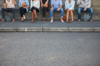 Buy stock photo Low, street and legs of people in the city for bonding, social and community event. Urban, together and friends or a group sitting on the sidewalk of the road for solidarity, party or society