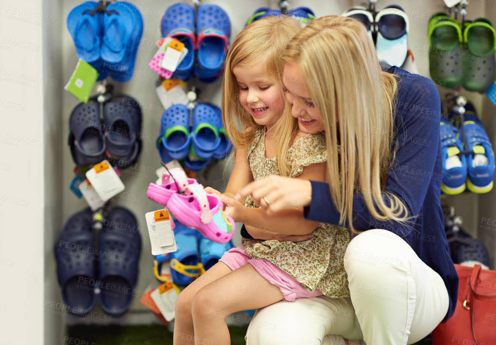 Buy stock photo Shot of a mother and daughter out shoe shopping in the mall