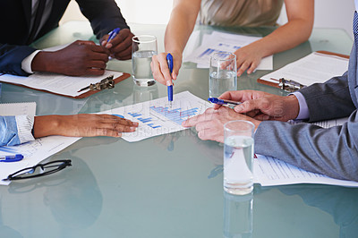 Buy stock photo Cropped shot of a group of businesspeople discussing financial documents in a meeting