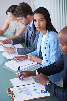 Buy stock photo Portrait of a young businesswoman in a meeting with her colleagues