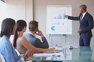 Buy stock photo Shot of a business manager presenting financial data to his colleagues during a meeting