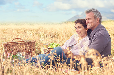 Buy stock photo Happy, senior couple and picnic in park, grass and basket in nature for a date in retirement with love or care. Mature, woman and man in field in summer, holiday or vacation with freedom and support