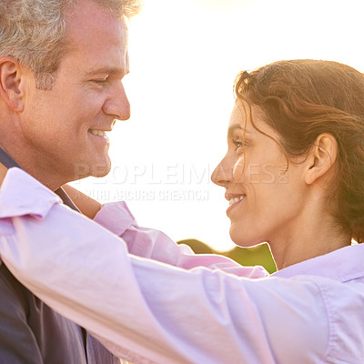 Buy stock photo Old couple, smile and embrace at sunset with love, trust and support in marriage and retirement. Happy, woman and care for partner on holiday with freedom, health and wellness at the beach for cruise