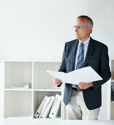 Buy stock photo Businessman, standing and documents in office or thinking for contract, report information or confidential file. Male person, suit and company paperwork or corporate agreement, decision or folder