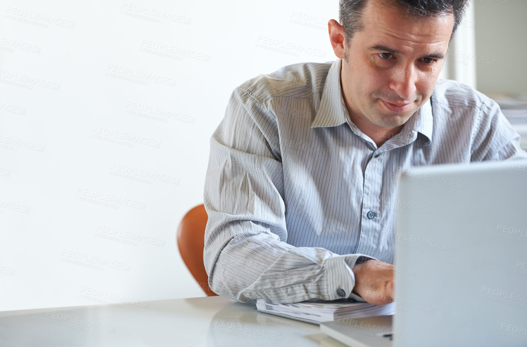 Buy stock photo Cropped shot of a stressed out businessman using a laptop