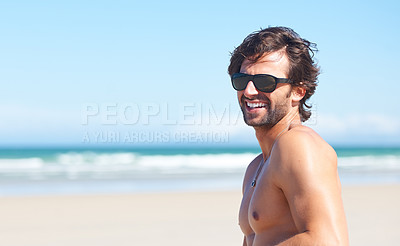 Buy stock photo Nature, sunglasses and laugh or a man on the beach for travel, freedom or adventure on vacation. Summer, space and a young person shirtless by the ocean or sea on a tropical coast for holiday