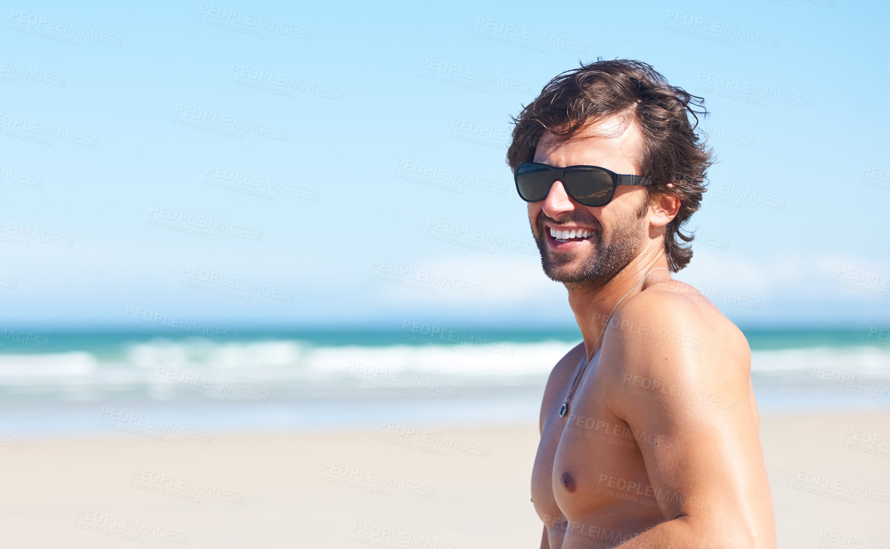 Buy stock photo Nature, sunglasses and laugh or a man on the beach for travel, freedom or adventure on vacation. Summer, space and a young person shirtless by the ocean or sea on a tropical coast for holiday