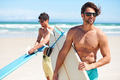Buy stock photo Two friends at the beach getting ready to head into the water for a surf