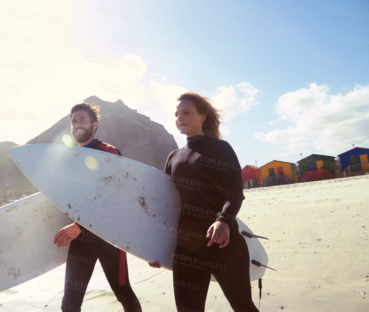 Buy stock photo Shot of an athletic young couple surfing at their favourite beach