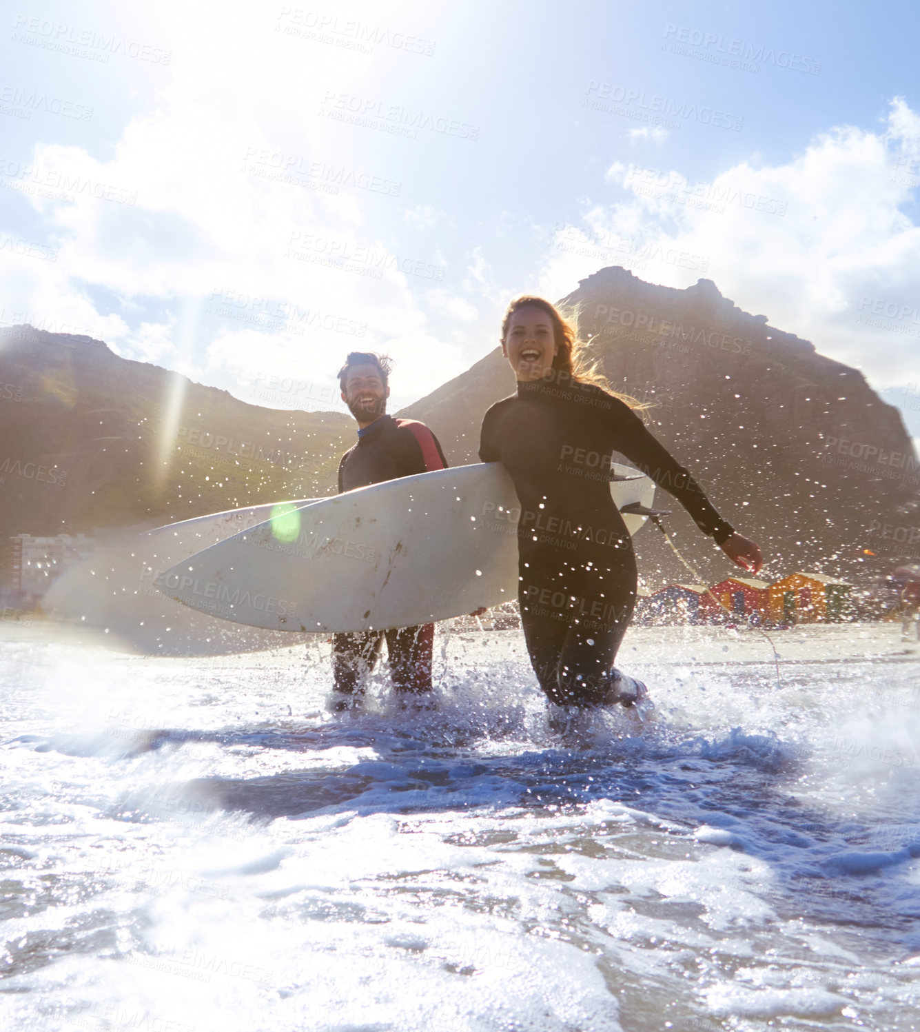 Buy stock photo Shot of an athletic young couple surfing at their favourite beach