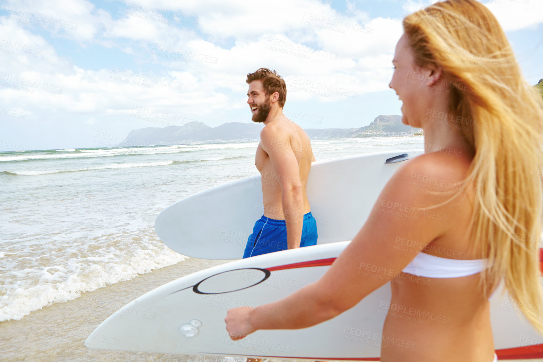 Buy stock photo Shot of a young couple out surfing at the beach