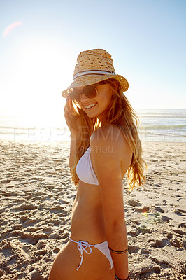 Buy stock photo Portrait of an attractive young woman in a bikini enjoying a day at the beach