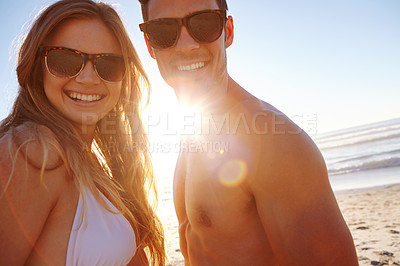 Buy stock photo Portrait of a young couple enjoying the late afternoon sun at the beach