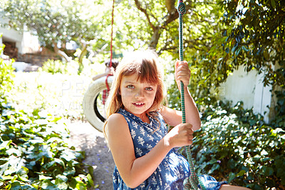 Buy stock photo Cropped shot of a young girl swinging in the yard