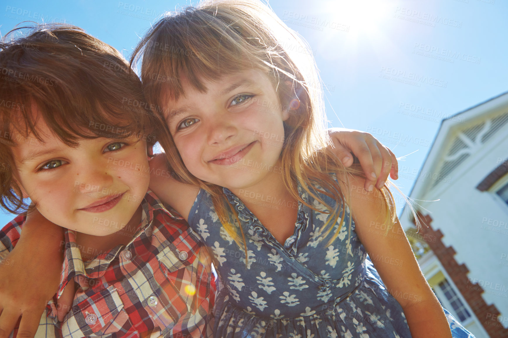 Buy stock photo Shot of an affectionate brother and sister embracing in their backyard